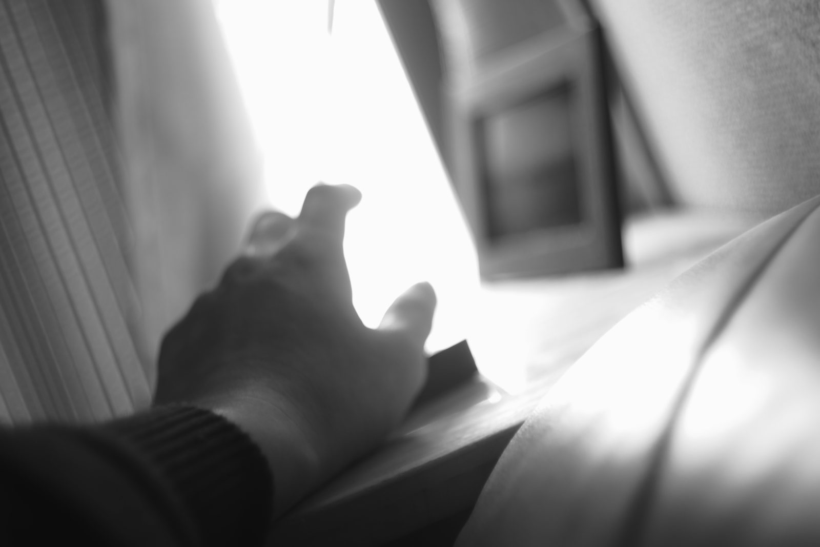 Eine Hand auf Papier im Gegenlicht eines Fensters
